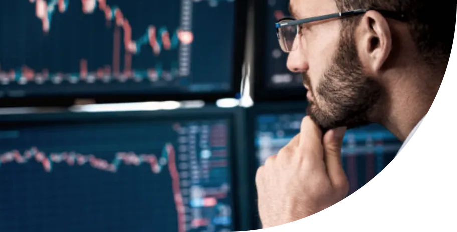A man with glasses looking at a wall of stock.